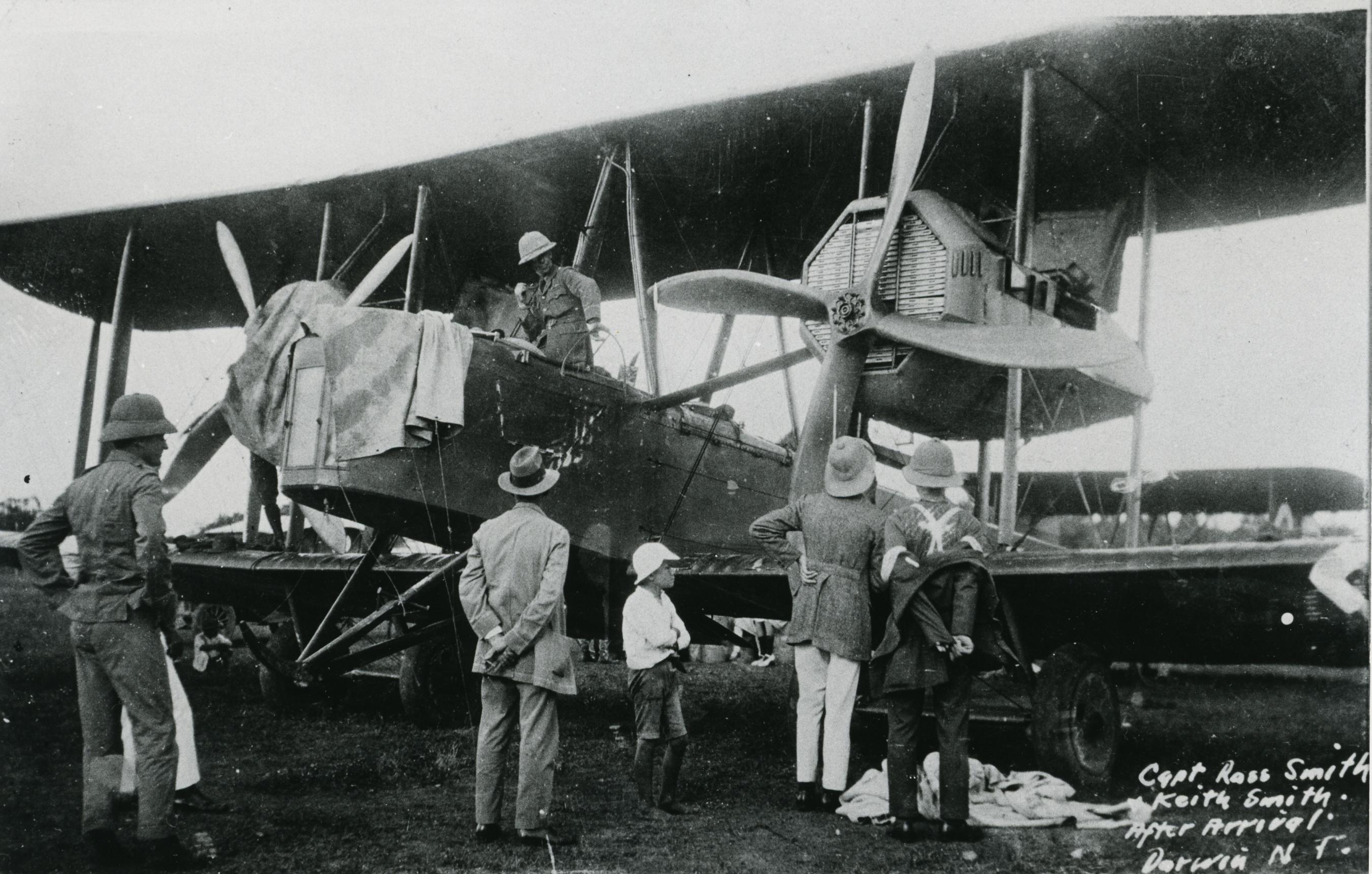Group of people inspecting a plane on the ground