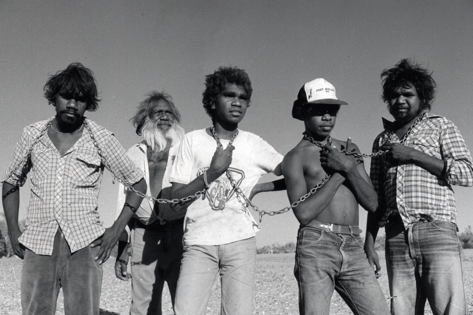 Five Aboriginal men posing with chains around their neck as part of the protest taking place in the Pilbara region in Western Australia