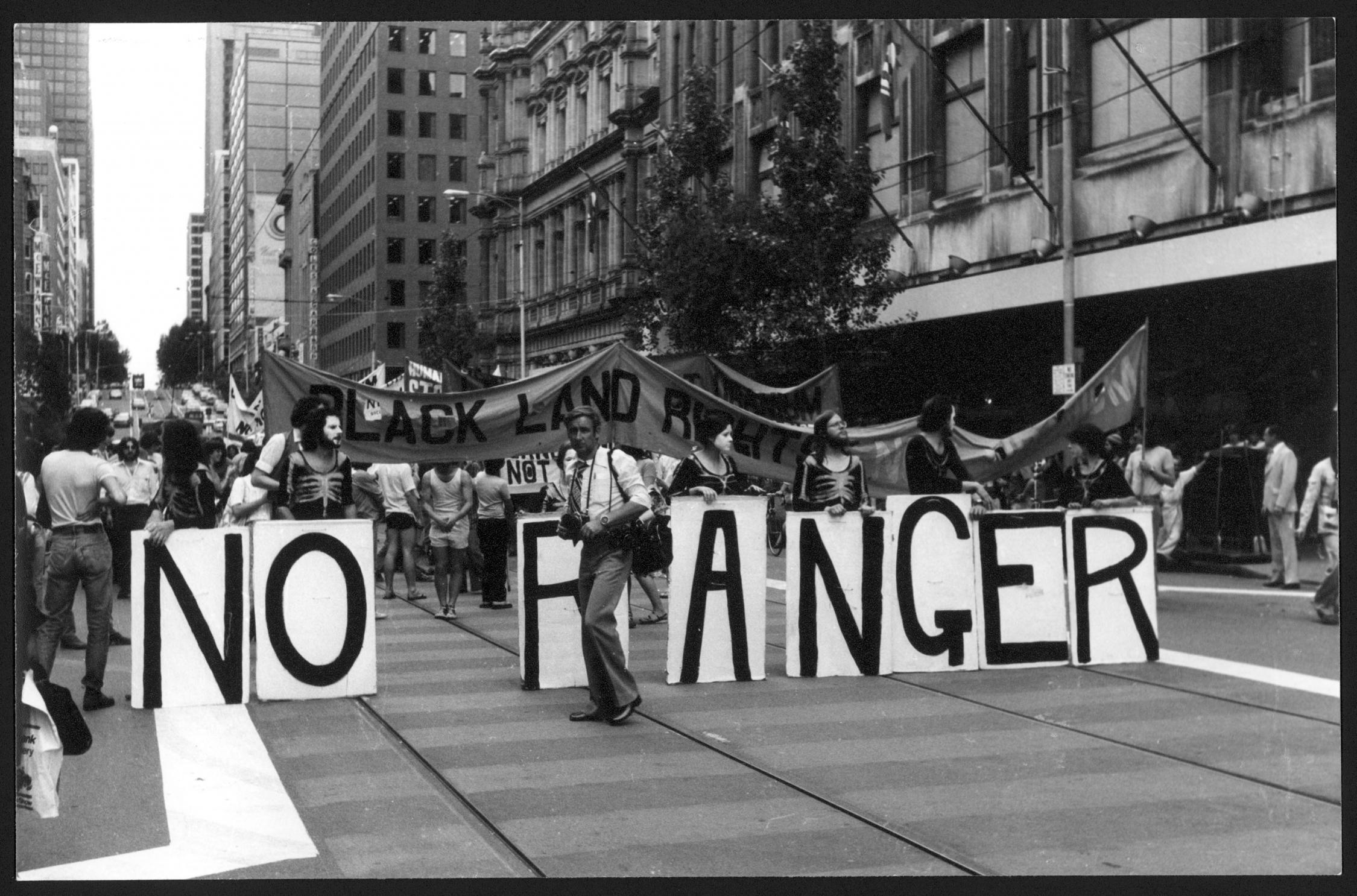 Street protest featuring a 'No Ranger' sign.