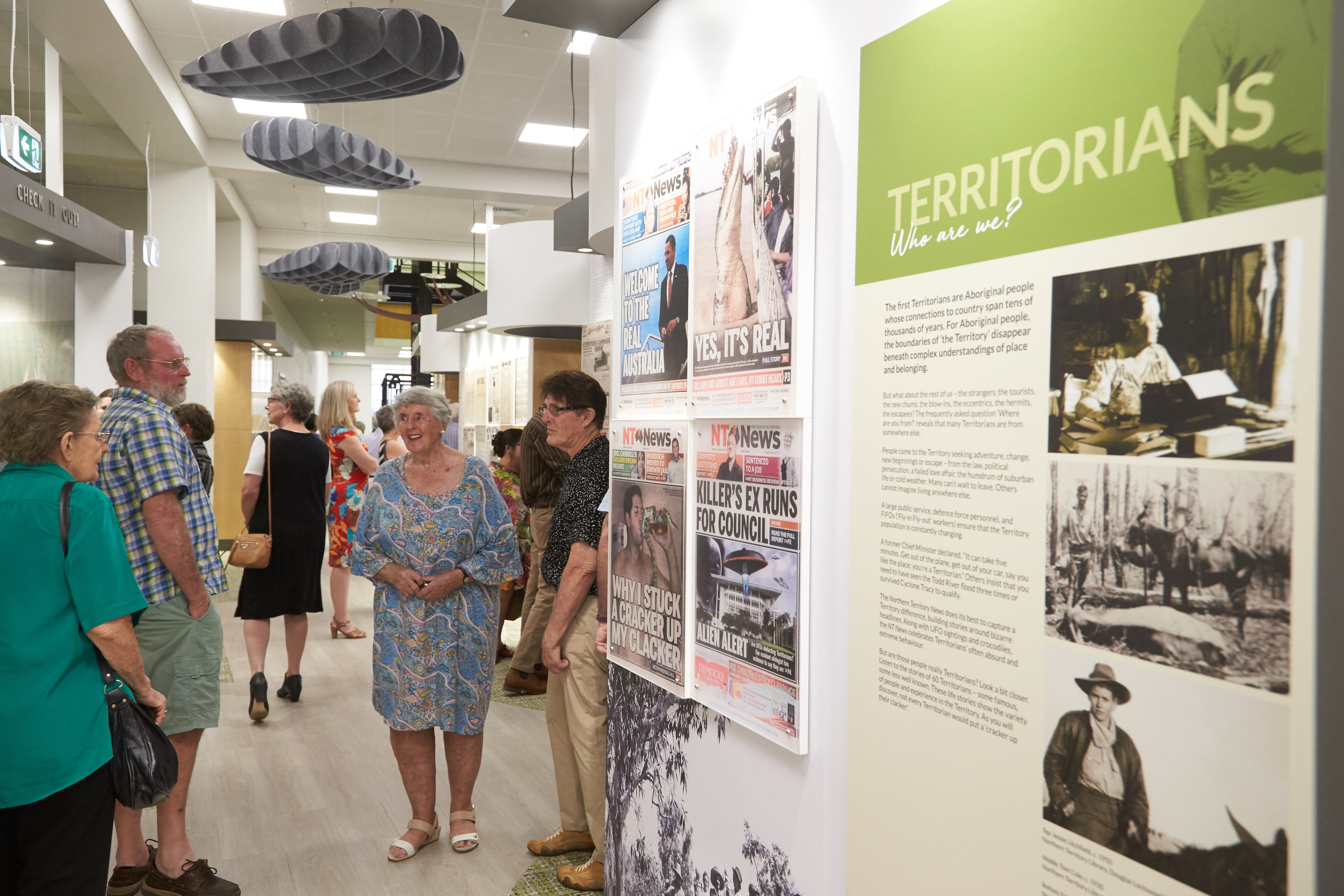 People walking and viewing A Territory Story exhibition